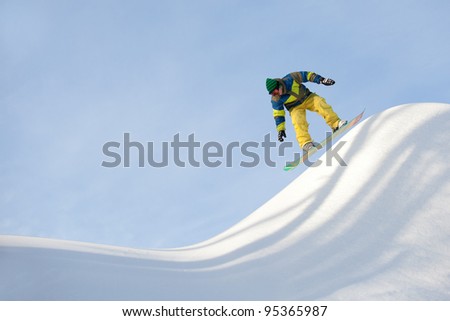 snowboarder riding in half-pipe