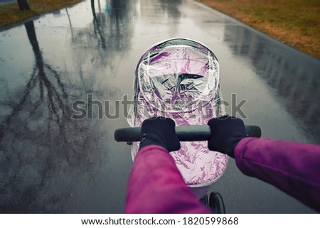 Similar – Image, Stock Photo Stroller in the rain with umbrella