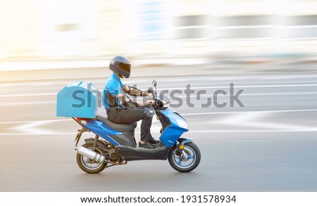 Food delivery boy on motorcycle moving fast to deliver food to customers, home and office delivery on motorbike, pizza online order. Express delivery service from cafes and restaurant, internet orders
