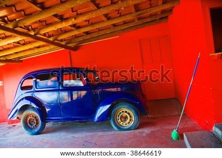 Old-time blue car in old garage, Costa Rica.