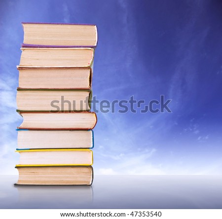 Big books stack in bright blue background
