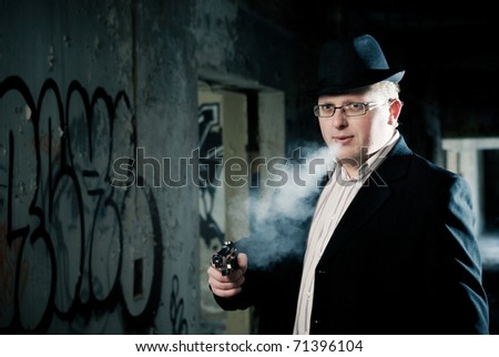 young detective smoking and aiming with gun.