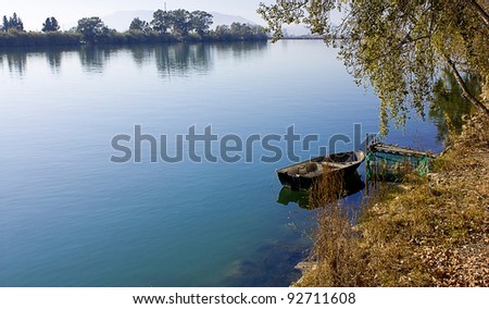 Lakefront landscape in autumn,a boat in the lake.