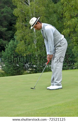 MOSCOW - JULY 05: Russian unknown golfer finishes his swing on annual event  for professionals and fans, VI Moscow Festival Retrostyle in Le Meridien Moscow County Club July 05, 2007 in Moscow, Russia