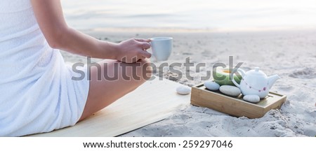 Yoga woman meditating at serene beach sunset