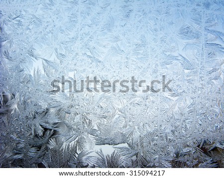snowflakes ornament on glass winter texture background