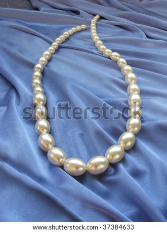 white beads on blue material background