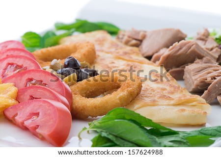 Tuna fish with onion rings on plate isolated on white background