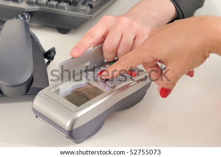 A woman swiping a credit card.