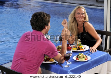 An attractive young woman on romantic date with her sweetheart - a series of RESTAURANT images.