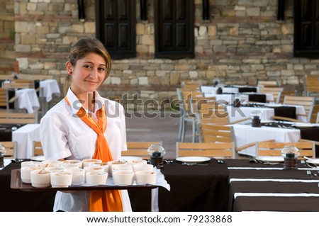 Cheerful waiter serving at old fashioned restaurant.