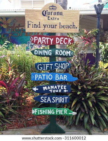 PONCE INLET, FL-AUGUST, 2015:  Sign outside of a local water front  restaurant near Daytona Beach shows the directions for dining , gift shop, manatee tours, fishing and patio bar.