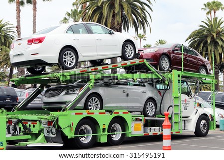 NEWPORT BEACH, CA-AUGUST, 2015:  Load of new Chevrolet and Buick cars being delivered to a dealership in Southern California.