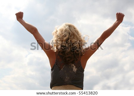 Woman holding her arms up - outdoors