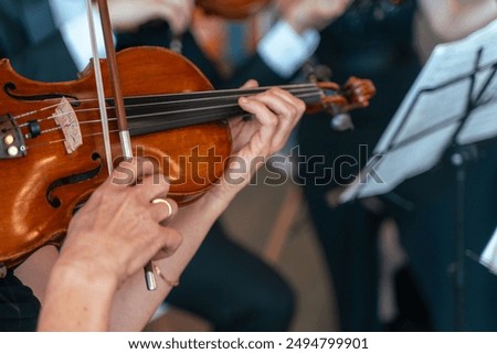 Similar – Image, Stock Photo Violin and bow in the hand of the musician in an empty room. Ban on performing in the Corona Crisis