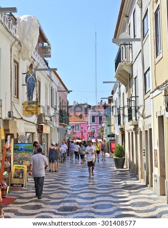CASCAIS, PORTUGAL - SEPTEMBER 13, 2013 : People walk on old town street. Cascais is popular tourist destination near city of Lisbon