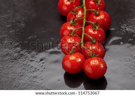 Fresh and wet cherry tomatoes with green