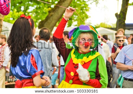 ZBARAZH, UKRAINE  MAY 6: Unidentified women acting as a clown and Snow White near Zbarazh castle during Tourist season opening festival in Zbarazh Castle on May 6, 2012 in Zbarazh, Ukraine.