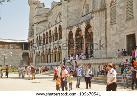 ISTANBUL, TURKEY - JUNE 03: Tourists in the courtyard of Sultanahmet Mosque on June 03, 2012 in Istanbul, Turkey. This is the biggest mosque in Istanbul of Sultan Ahmed is a great tourist attraction.