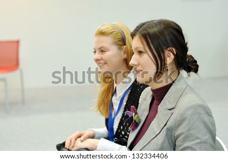 LEIPZIG, GERMANY - MARCH 15: Two unidentified women attend Public day at Leipzig Book fair on March 15, 2013 in Leipzig, Germany. Leipzig Book Fair is the most important spring meeting place for the publishing and media sector.