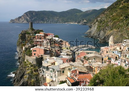 colorful houses piled on a rocky nose on the coast line