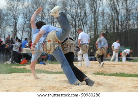 BONSTETTEN - APRIL 11: Swiss wrestling athletes fight for victory by throwing their opponent on his back April 11, 2010 in Bonstetten, Switzerland.  Overall victory was claimed by Jodok Huber.