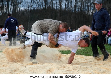 BONSTETTEN - APRIL 11: Swiss wrestling athletes fight for victory by throwing their opponent on his back April 11, 2010 in Bonstetten, Switzerland.  Overall victory was claimed by Jodok Huber.