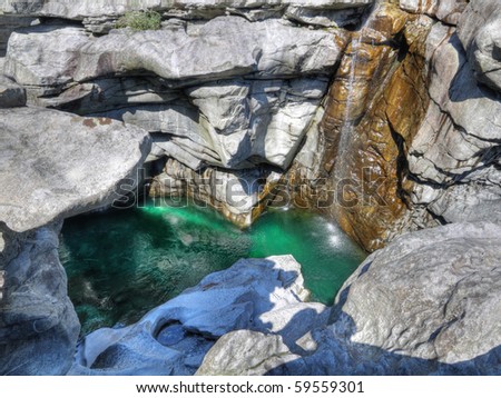 green water of deep cut gorge of river maggia near Locarno Switzerland called Ponte Brolla
