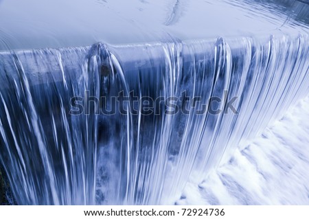 water cascade streaming down a lasher, cool white balance, concept for water saving, conservation, keeping water clean