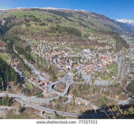 spring alpine panorama of little mountain town in valley in large street and rail infrastructure, Thusis Switzerland