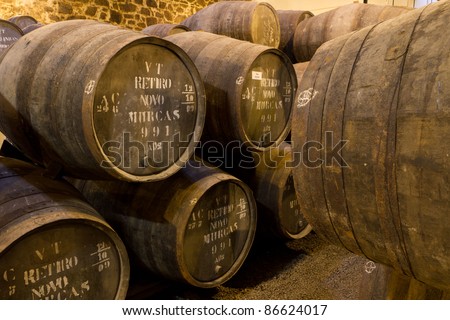 wooden barrels hold Port fortified wine to mature in wine cellars in Villa Nova de Gaia, Portugal