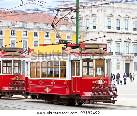historic classic red tram of Lisbon built partially of wood in front of Lisbons central square Praca de Comercio, Portugal