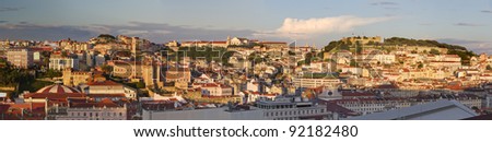 historic city center of Lisbon with castle and churches spread on several hills at sunset, Portugal