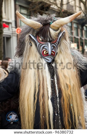 ZURICH - FEBRUARY 26: Participants in costumes perform a street procession of ZueriCarneval Fasnacht February 26, 2012 in Zurich, Switzerland. They perform Gugge Music and dress up as witches.