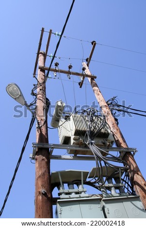 Old electricity transformer. Old wooden post with electric power transformer.