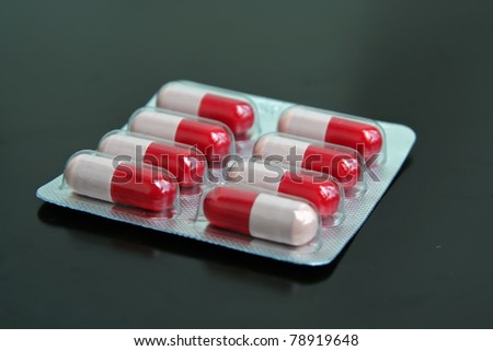 Pharmaceutical products. Red and white pills. Pills with antibiotic.