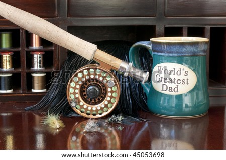 Fly Rod being prepared for a day of fly fishing.  Coffee mug indicating the World\'s Greatest Dad