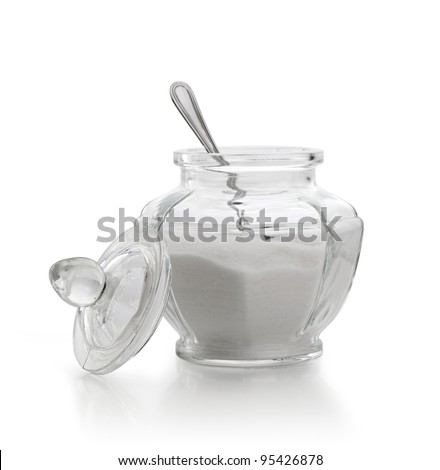 An old sugar bowl with spoon on white background