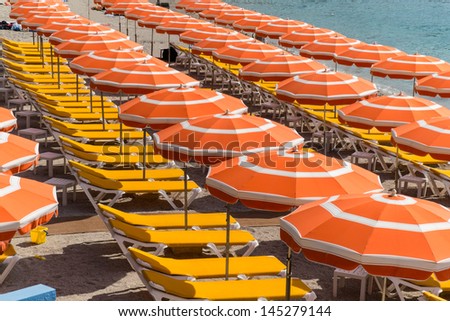 Brightly colored  beach umbrellas in rows