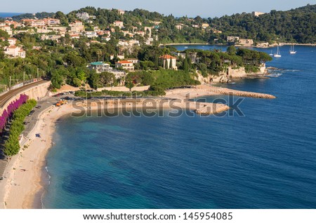 The beach of Villefranche sur Mer with Beaulieu and Cap Ferrat in the background