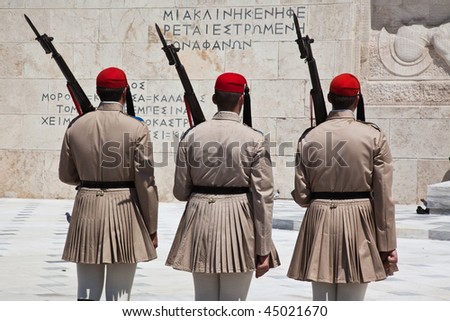 ATHENS - JULY 24: Ev zone guards dressed in traditional Greek uniform changing the guard  at the Greek Parliament Building in front of Syntagma Square on July 24, 2009 in Athens, Greece.