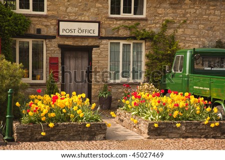 Post Office in England with vintage truck parked outside in spring sunshine