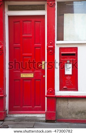 Post Box next to a red door