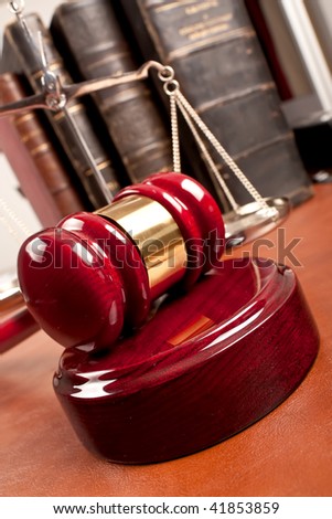 Old book and gavel on leather desktop