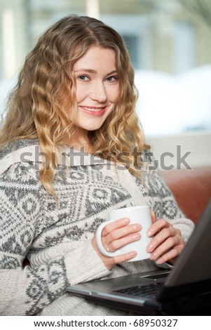 Young woman relaxing on the couch surfing