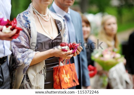 Woman holding rose petals at the wedding