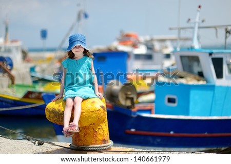 Adorable little girl at fisherman village in Greece