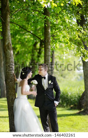 Beautiful bride and groom by a tree