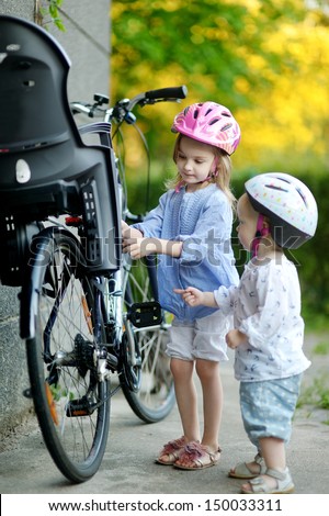 Two little sisters going to have a bicycle ride