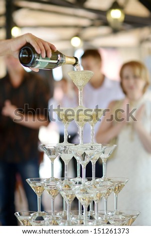 Pouring champagne into fancy glasses